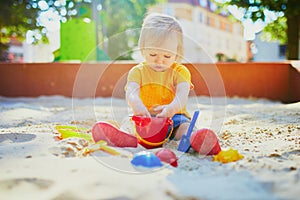 Adorable little girl on playground on a sunny day