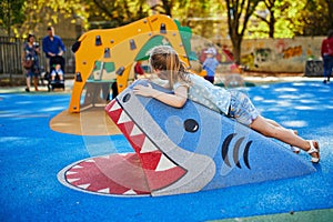 Adorable little girl on playground on a sunny day