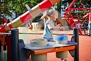 Adorable little girl on playground on a sunny day