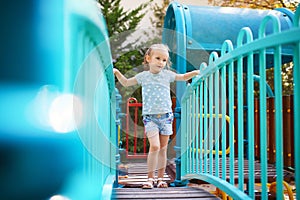Adorable little girl on playground on a sunny day