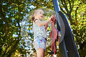 Adorable little girl on playground on a sunny day