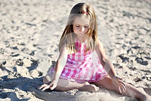Adorable little girl playing on beach