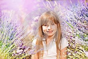 Adorable little girl playing in lavender field