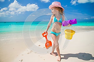 Adorable little girl playing with sand on a photo