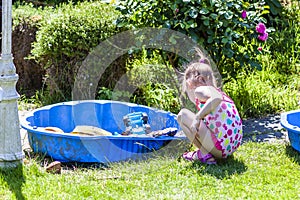 Adorable little girl playing in a sandbox