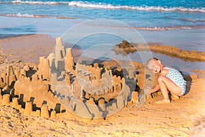 Adorable little girl playing at the seashore