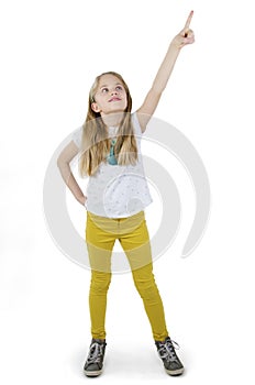 Adorable little girl pointing empty copy space. Cute little girl with index finger up.