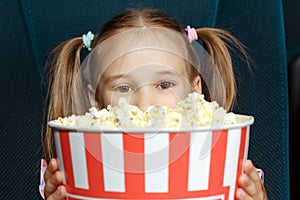 Adorable little girl with popcorn