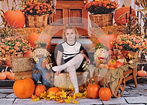 Adorable little girl posing on fall backdrop