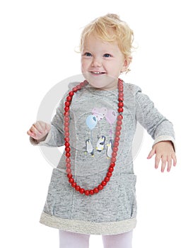 Adorable little girl put on her big red beads