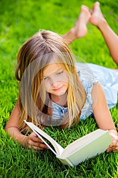 Adorable little girl reading book