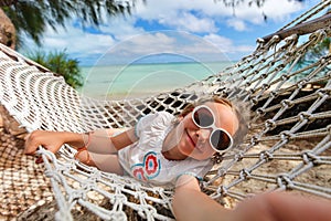 Adorable little girl relaxing in hammock