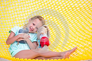 Adorable little girl relaxing in hammock