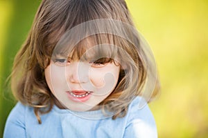 Adorable little girl with sad expression of her face, going to cry.