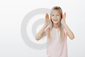 Adorable little girl showing dance moves she learnt. Portrait of active happy young european child with fair hair