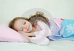 Adorable little girl sleeping in her bed