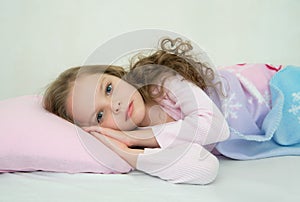 Adorable little girl sleeping in her bed