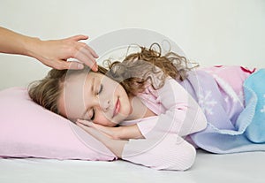 Adorable little girl sleeping in her bed