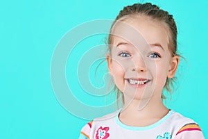Adorable little girl smiling and showing off her first lost milk tooth. Cute preschooler portrait.