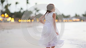 Adorable little girl at tropical beach during vacation