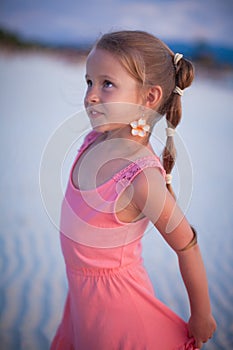 Adorable little girl on tropical beach vacation in