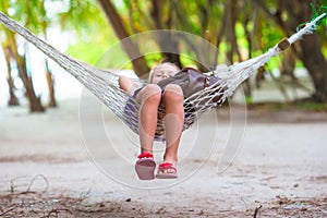 Adorable little girl on tropical vacation relaxing