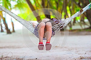Adorable little girl on tropical vacation relaxing