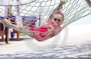 Adorable little girl on tropical vacation relaxing