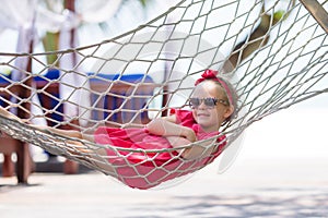 Adorable little girl on tropical vacation relaxing