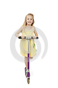 Adorable little girl using a scooter
