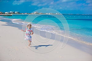 Adorable little girl at white beach during summer