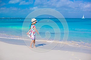 Adorable little girl at white beach during summer