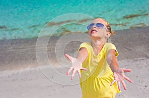 Adorable little girl at white beach during summer