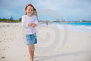 Adorable little girl at white beach during summer