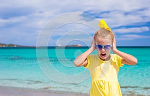 Adorable little girl at white beach during summer