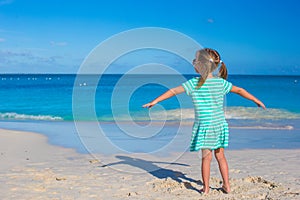 Adorable little girl at white beach during summer