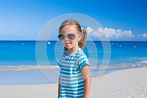 Adorable little girl at white beach during summer