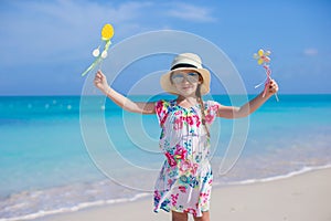Adorable little girl at white beach during summer vacation