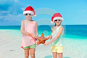 Adorable little girls on Christmas beach vacation.