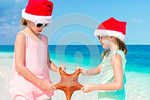 Adorable little girls on Christmas beach vacation.