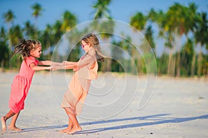 Adorable little girls have fun on the beach