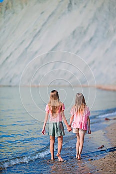 Adorable little girls having fun on the beach