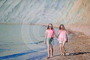 Adorable little girls having fun on the beach