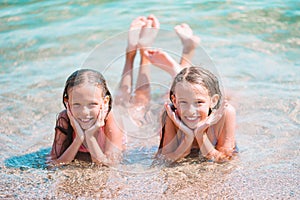 Adorable little girls having fun on the beach