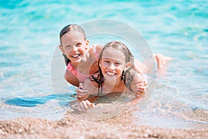 Adorable little girls having fun on the beach