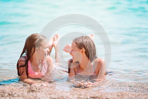 Adorable little girls having fun on the beach