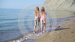 Adorable little girls having fun on the beach