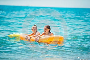 Adorable little girls having fun on the beach