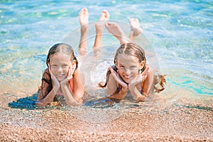 Adorable little girls having fun on the beach