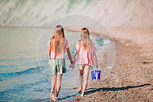 Adorable little girls having fun on the beach